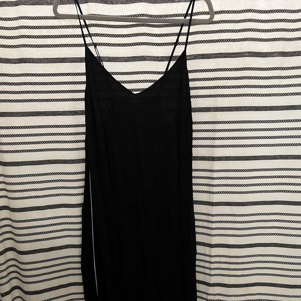 Black slip dress with white piping on the sides and snaps.